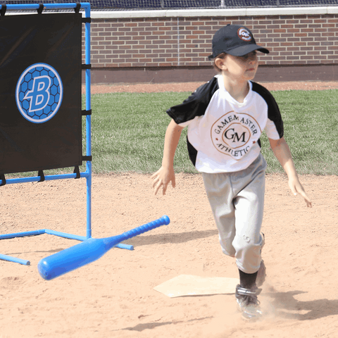 Young athlete practicing with Blitzball StrikeZone Target and bat on a sandy baseball field.