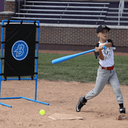 Young boy swinging a bat at a baseball near the Blitzball StrikeZone Target during practice