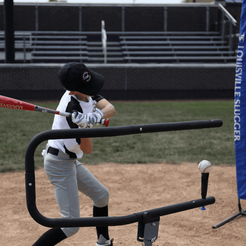 Youth athlete practicing with baseball swing trainer bundle on a baseball field for skill development
