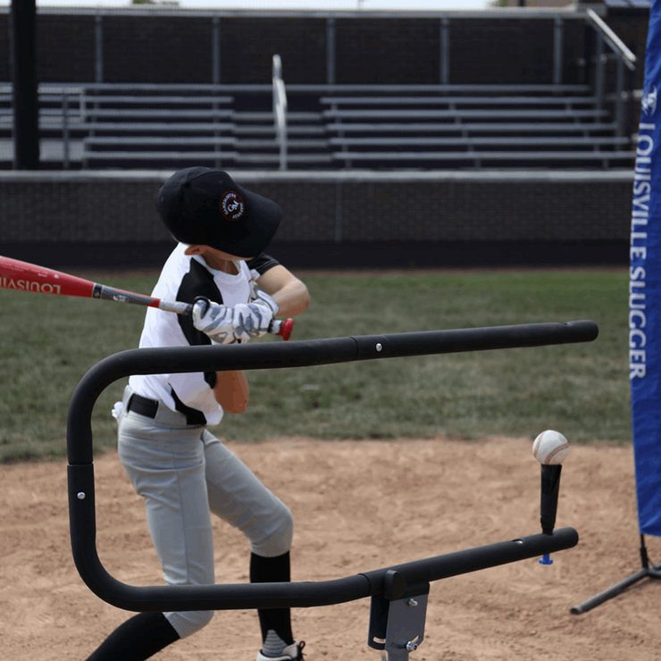 Youth athlete practicing with baseball swing trainer bundle on a baseball field for skill development