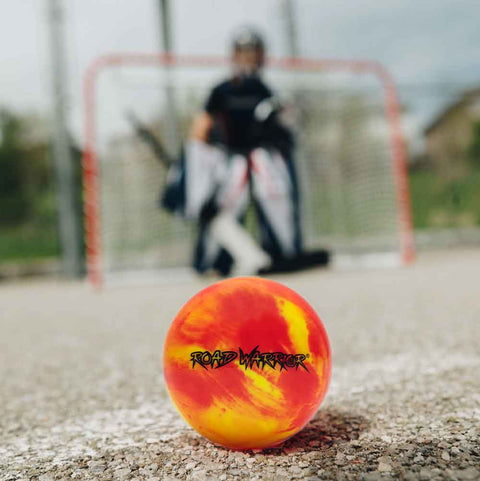 Road Warrior Street Hockey Balls - 15 Pack (Extreme Colours) with vibrant colors on a hockey court