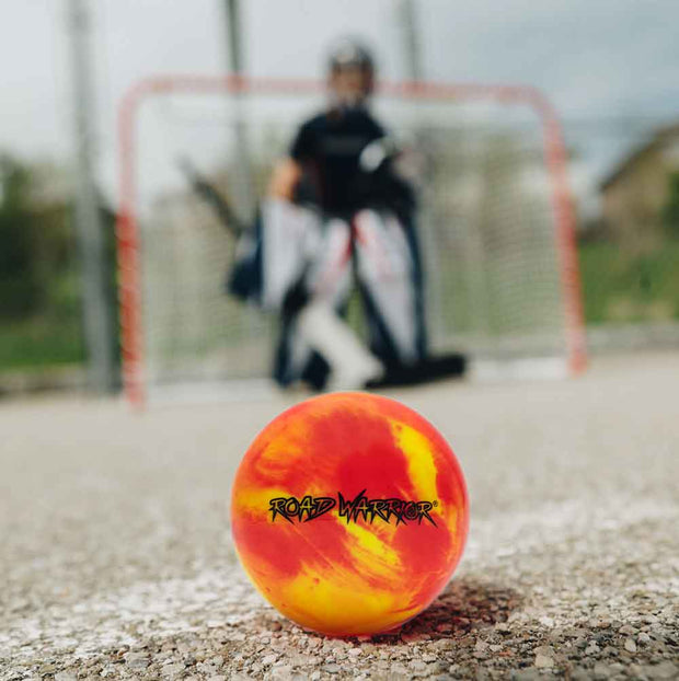 Road Warrior Street Hockey Balls - 15 Pack (Extreme Colours) with vibrant colors on a hockey court
