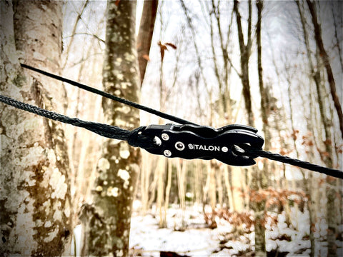 SNAP Talon Outdoor Quick Connector securely attached to a tree in a winter forest setting