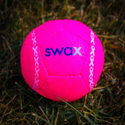 Pink Swax training softball designed for skill development and practice in various weather conditions