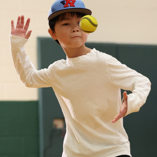 Young player practicing with a USA Baseball Baseball5 Ball in a gym setting