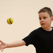 Young boy throwing a USA Baseball Baseball5 Ball during play, showcasing athletic skills