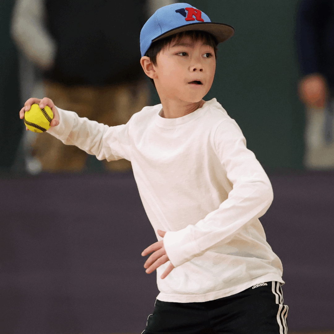 Young boy throwing a USA Baseball Baseball5 Ball during practice in a gymnasium
