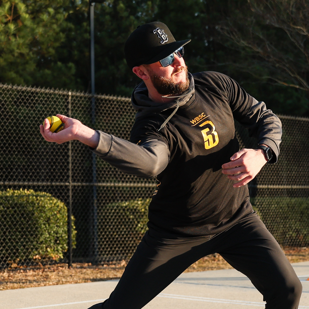 Player practicing with a USA Baseball Baseball5 Ball in outdoor training attire