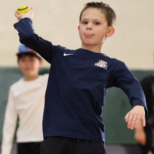 Boy throwing a USA Baseball Baseball5 Ball during a practice session in a gym