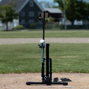 Louisville Slugger Black Flame pitching machine on a baseball field for effective batting practice