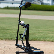 Louisville Slugger Black Flame pitching machine on a baseball field for practice and training.