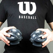 Louisville Slugger XBALL grip strength & recovery trainer held by a person in a baseball shirt