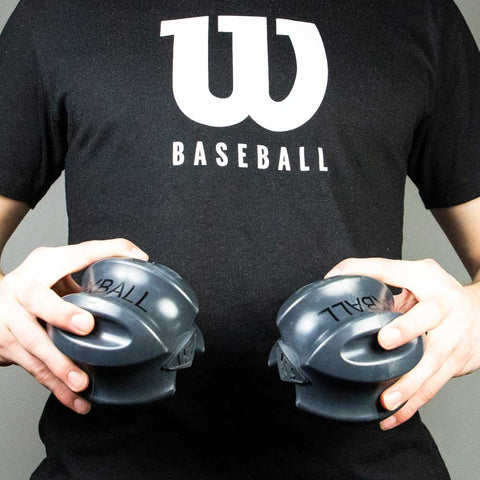 Louisville Slugger XBALL grip strength & recovery trainer held by a person in a baseball shirt