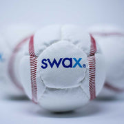 Close-up of Swax training baseball from Slugger Training with red stitching and soft exterior